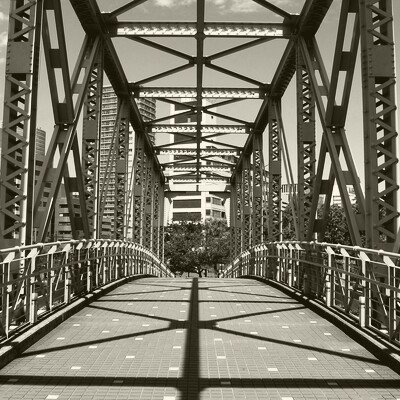Modern pedestrian bridge with sleek architectural design spanning between two contemporary buildings