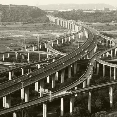 Aerial view of a modern highway interchange system in black and white, showing sophisticated engineering